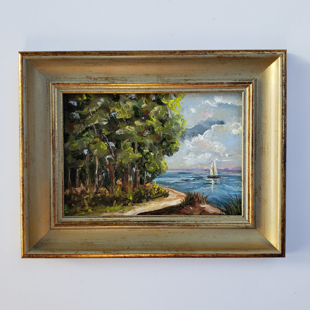 5x7 original oil painting... Nostalgic little painting of a sail boat and beautiful scene with puffy clouds and an inviting path to the water.