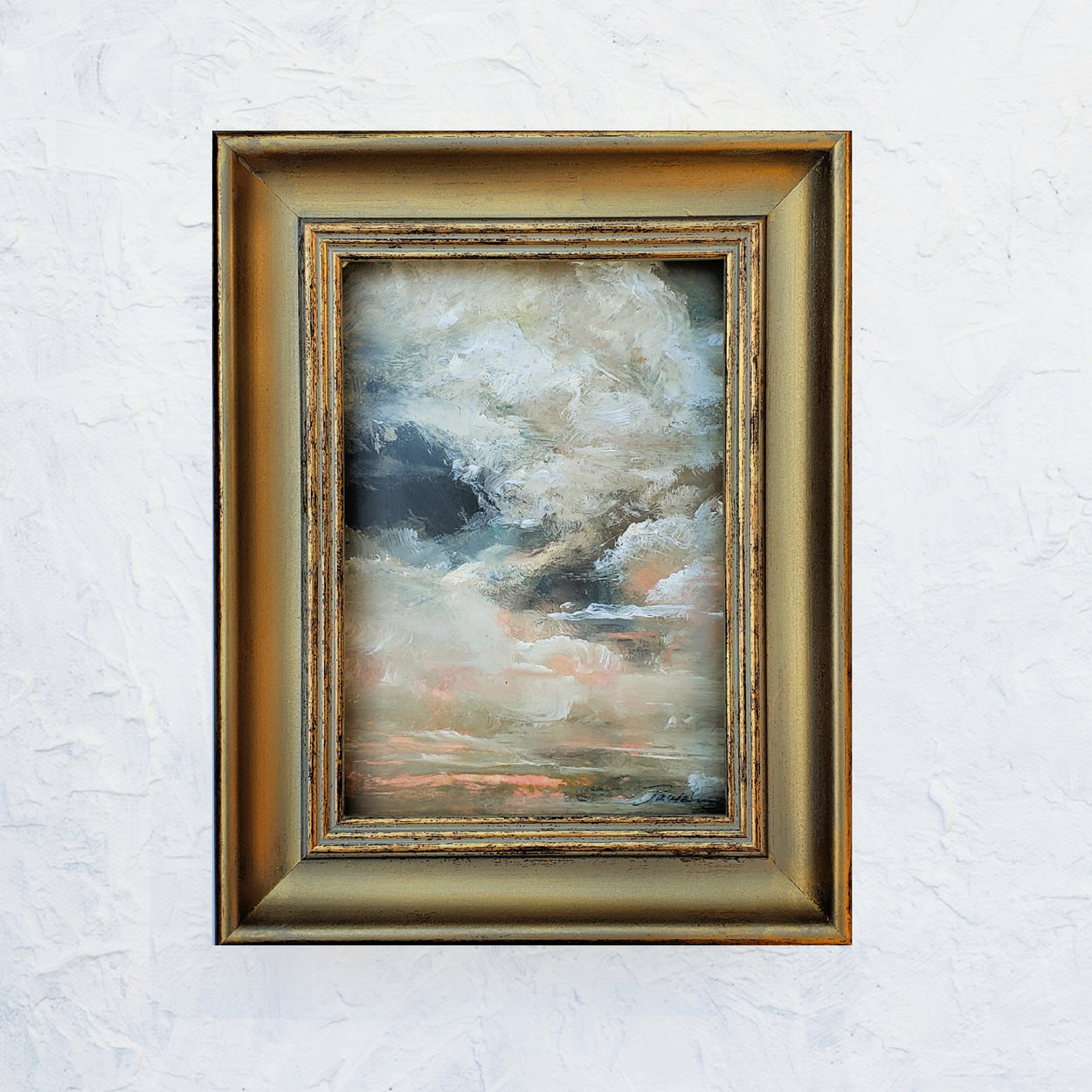 5x7 Oil on painting on oil paper..puffy clouds painted in colorse of peach and cream and dark gray blue with golden tones. Framed in vintage like gold frame.