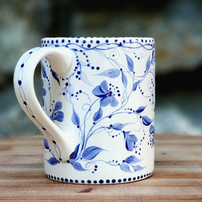 This hand painted blue and white mug has the look of Delft... sweet trailing vines and flowers circle around the entire piece. The soft satin glaze makes t feel so wonderful! 16 oz kiln fired ceramic mug