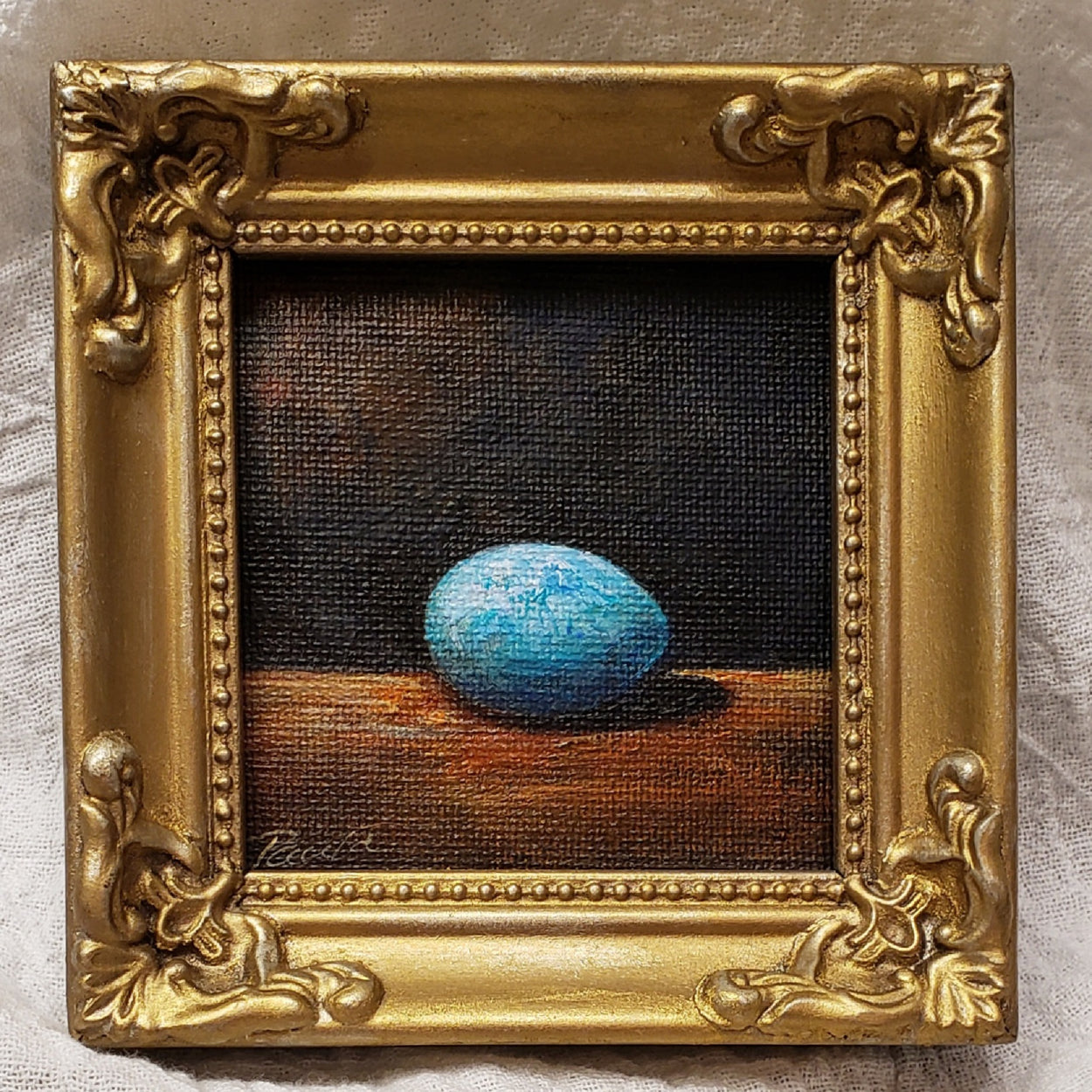The sweetest tiniest little painting of a bright aqua egg... Titled... "Keep Shining" painting is 3x3.. framed in a tiny little fancy gold frame.