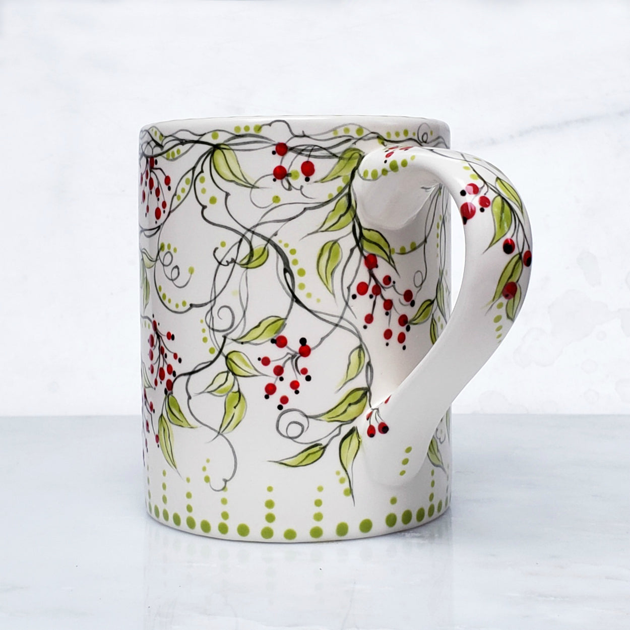 Hand painted red berry mug... with dark green vines and lime colored leaves this satin glazed mug is beautiful! 16 oz. kiln fired ceramic mug