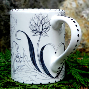 Beautiful Botanical hand painted black and white coffee mug with a Bunny and a Birdie flying by. 16 oz. kiln fired ceramic mug