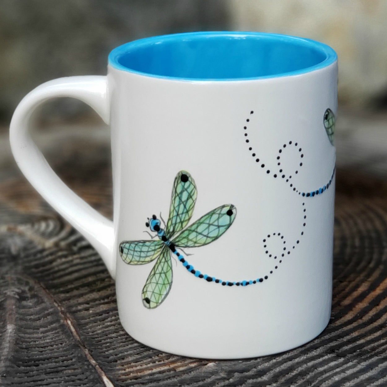Hand painted mug with Dragonflies swirling around the mug. The inside is glazed in a beautiful bright aqua... 16 oz kiln fried ceramic mug