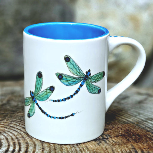 Hand painted Dragonflies swirling around a beautiful white mug with the brightest aqua inside! 16 oz. kiln fired ceramic mug