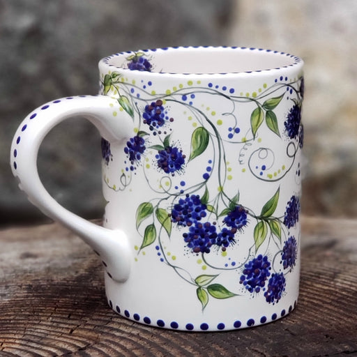 Hand painted Blackberries  and vines cover this entire mug. Dark blue with hints of purple berries and beautiful dark green vines and leaves make this one very special. 16 ox kiln fired ceramic mug