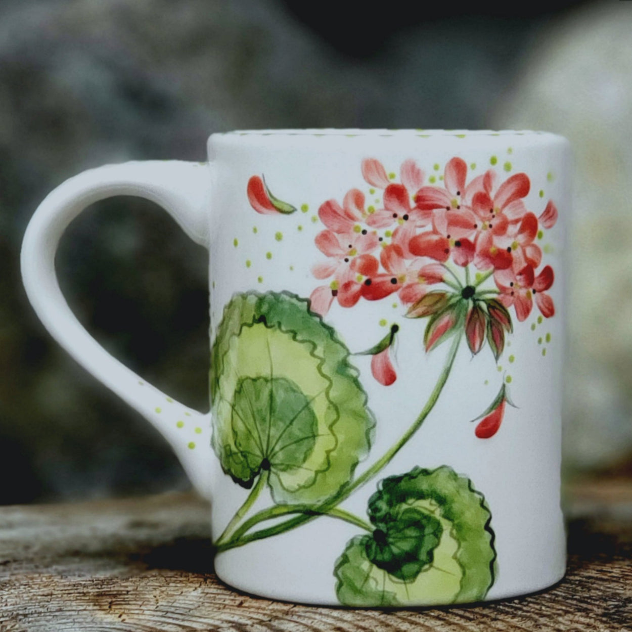 Beautiful hand painted mug with peachy Geraniums dancing all around it. kiln fired ceramic 16 oz. mug