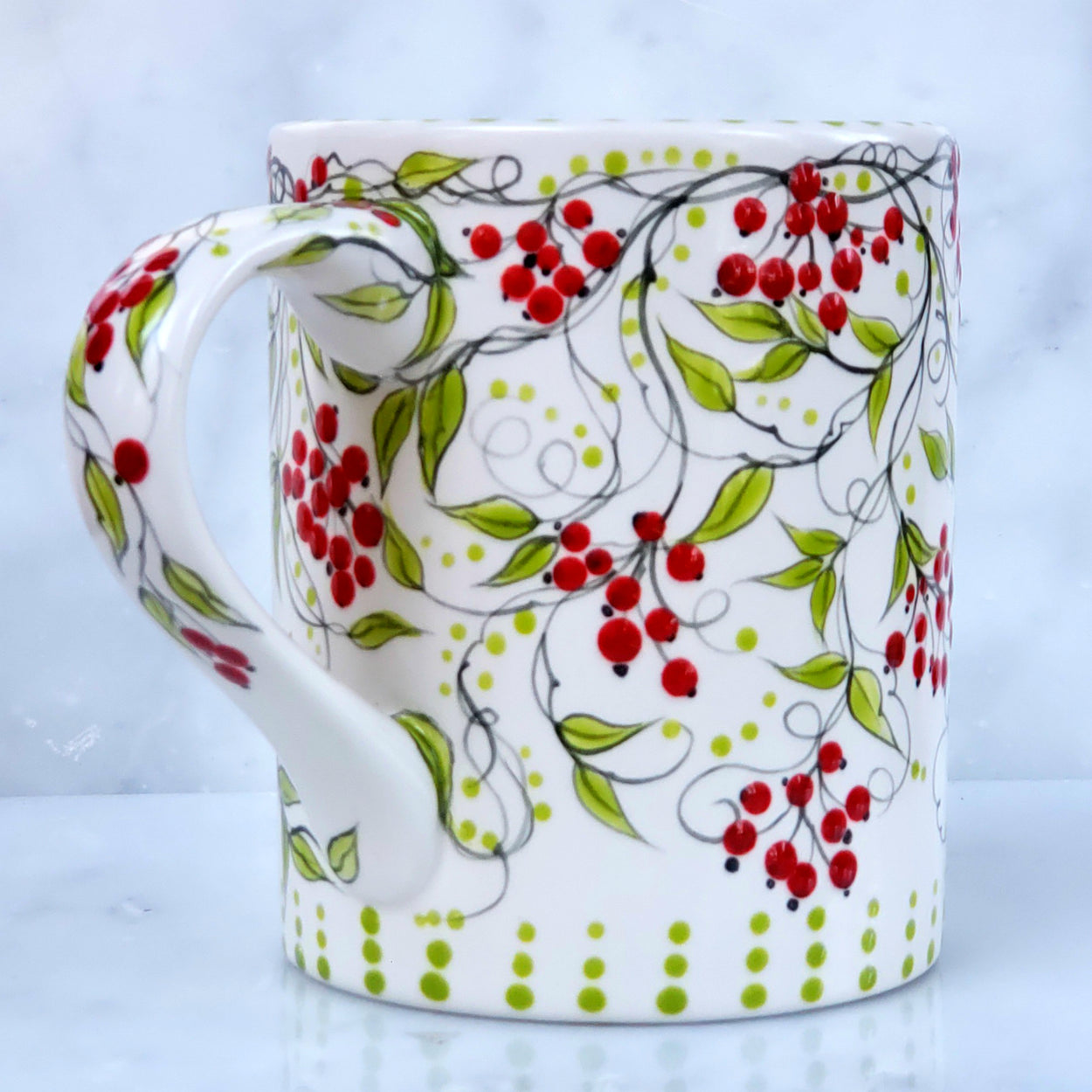 Hand Painted Mug with darling red berries, dark green vines and lime colored polka dots and leaves on a white background